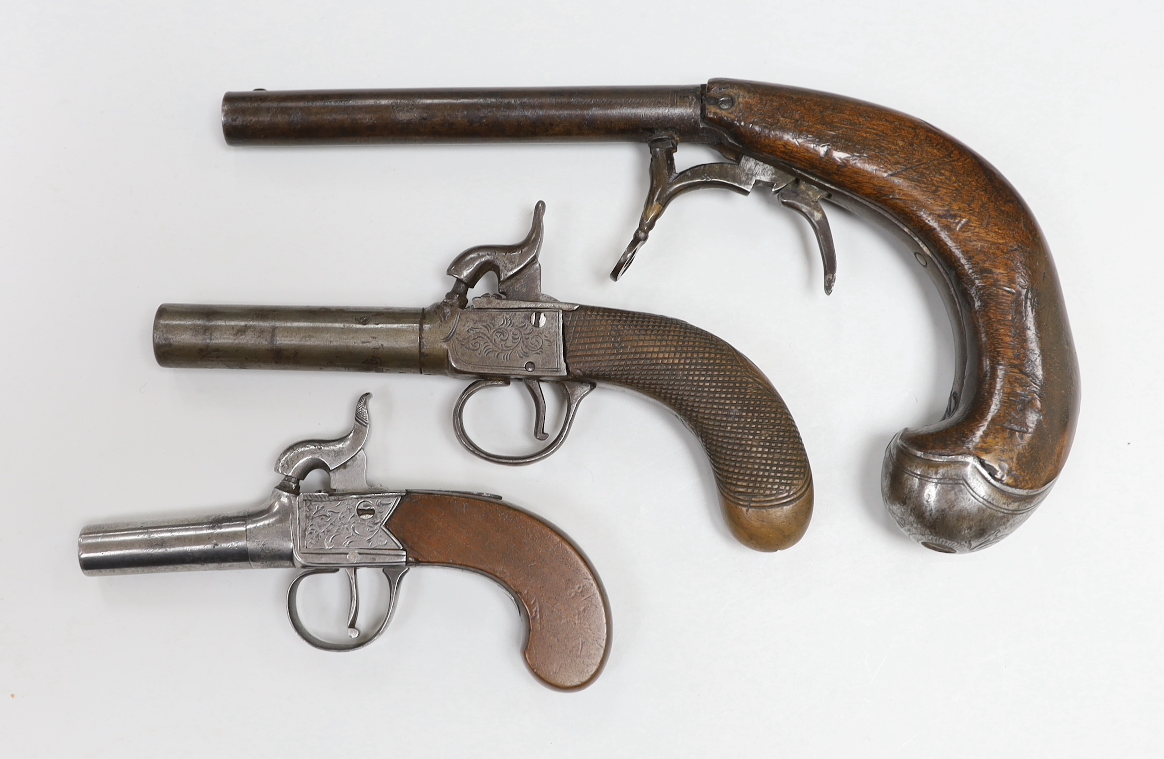 Two early 19th century percussion cap pocket pistols with turn off barrels, one signed ‘Young, Sheffield’ and a percussion cap boot pistol (3)